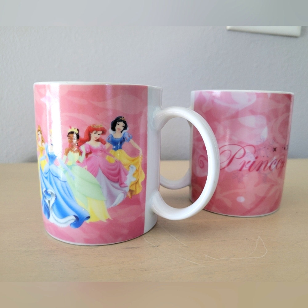 Pair of Disney Princess mugs with 7 characters pink background